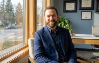 Confident man with full beard in modern Minnesota medical office after beard transplant consultation