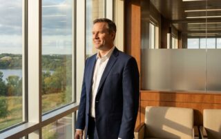 Confident man in modern Eagan Minnesota hair restoration specialist office with natural light and professional ambiance