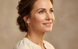 Confident woman with natural healthy hairline illustrating hair transplant options for receding hairline in women