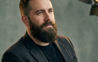 Confident man with a full, natural-looking beard showing realistic beard transplant density results