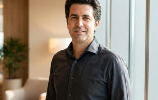 Confident man in his 40s with natural-looking full hair, representing realistic hair transplant expectations for men in their 40s.