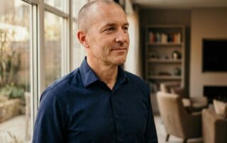 Confident man with shaved head considering scalp micropigmentation realistic expectations men should know