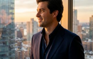 Confident man with natural full hairline near New York skyline, representing hair transplant results on Long Island.