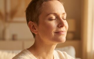 Woman with soft new hair regrowth after chemotherapy, representing the natural hair recovery journey