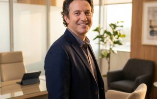 Confident man in modern hair restoration surgeon consultation office, representing qualified hair restoration surgeons near me