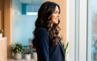 Confident person with healthy hair in a modern clinic, representing ideal Alma TED hair treatment candidacy