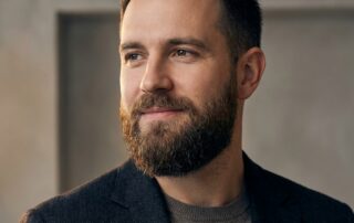 Confident man with full beard — understanding beard transplant cost per graft before your consultation