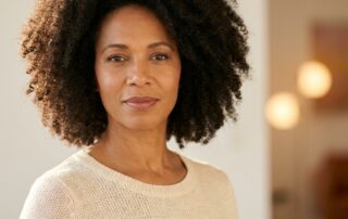 Confident woman with full healthy hair representing positive outcomes of FUE hair transplant for women