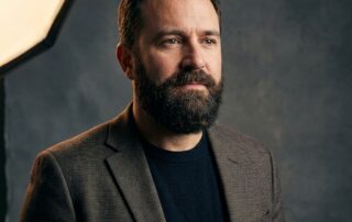 Confident man with a full natural beard, representing the aspirational results of an FUE beard transplant procedure.