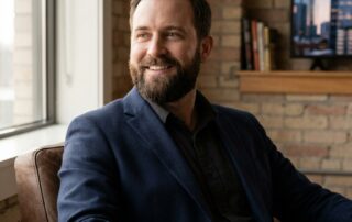 Confident man with full beard in modern consultation room, beard transplant Houston TX